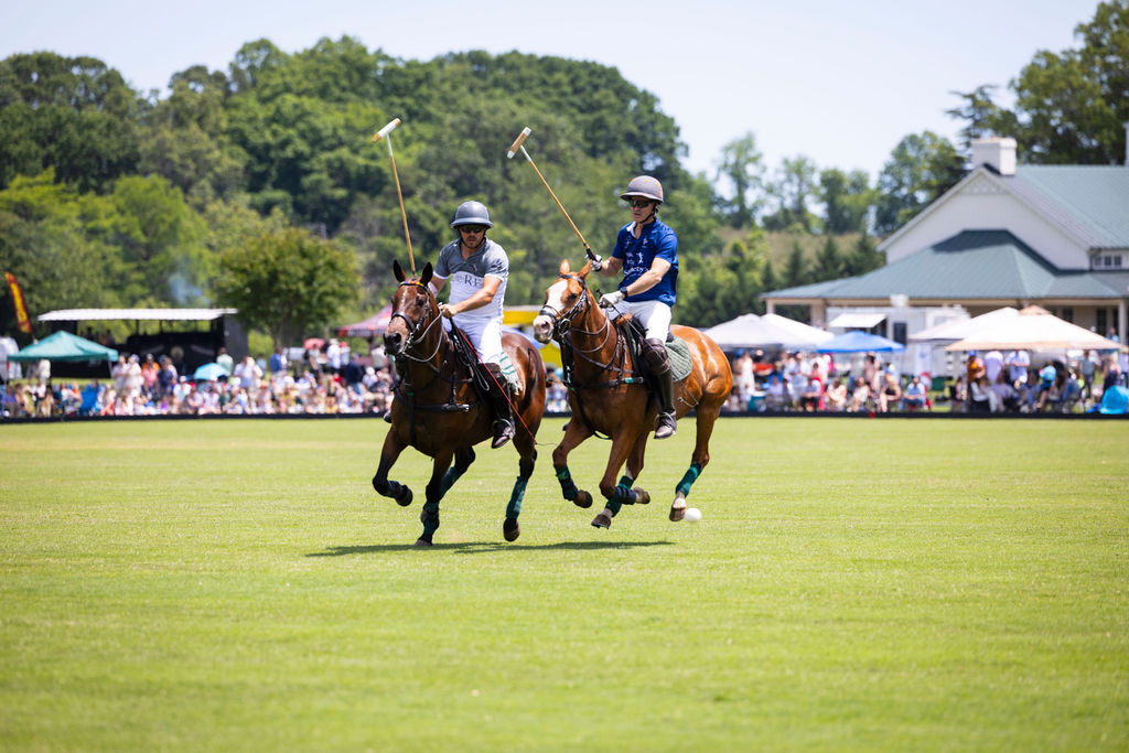 Polo players on horseback during a match at King Family Vineyards